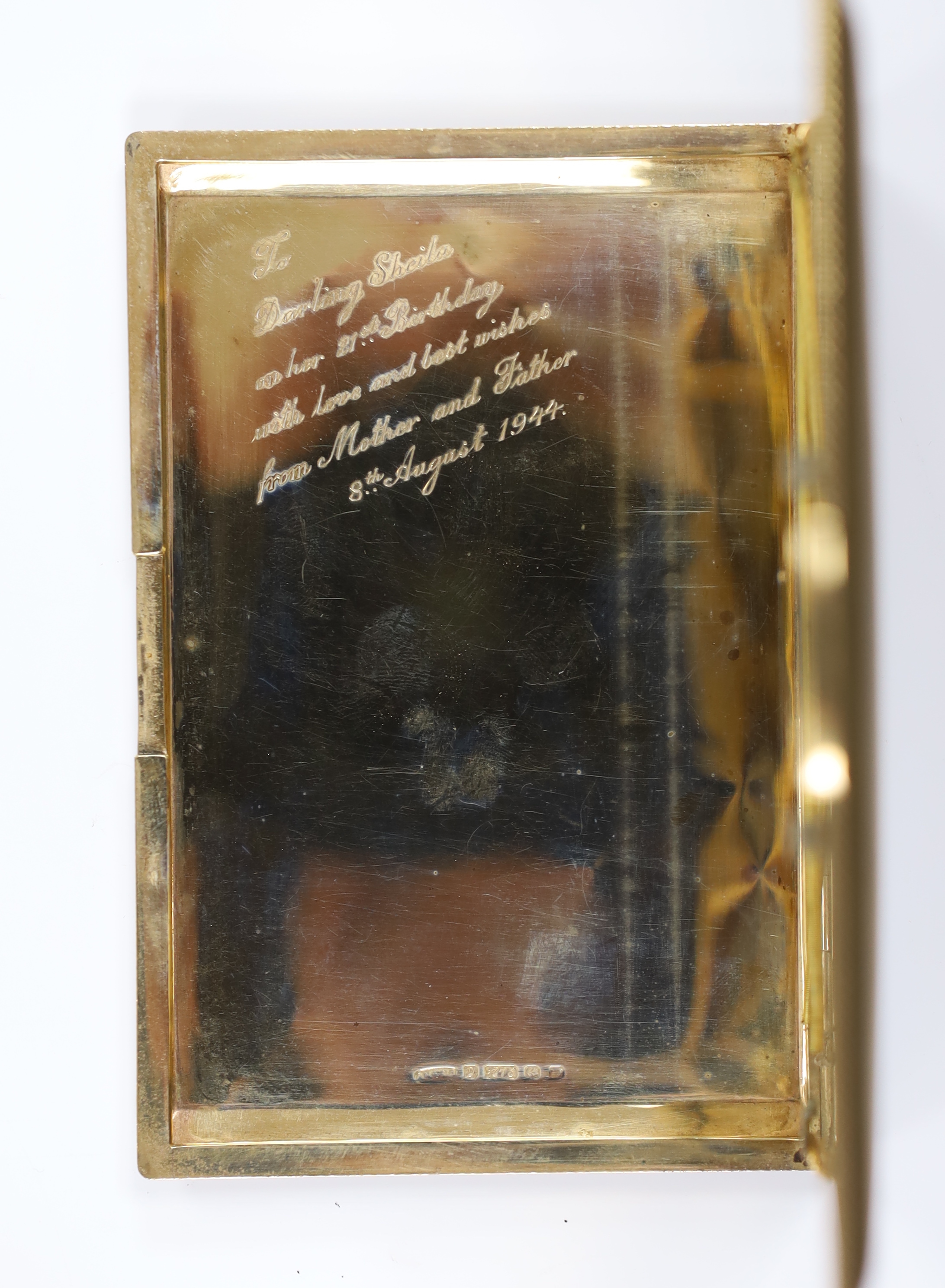 A 1940's engine turned 9ct gold cigarette case, with interior engraved inscription, 12.4cm, gross weight 171.2 grams.